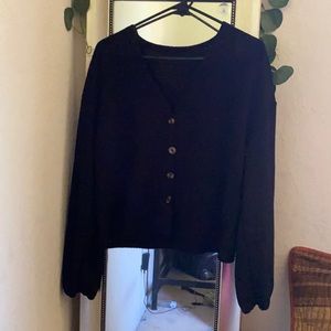 A black button up crop top sweater